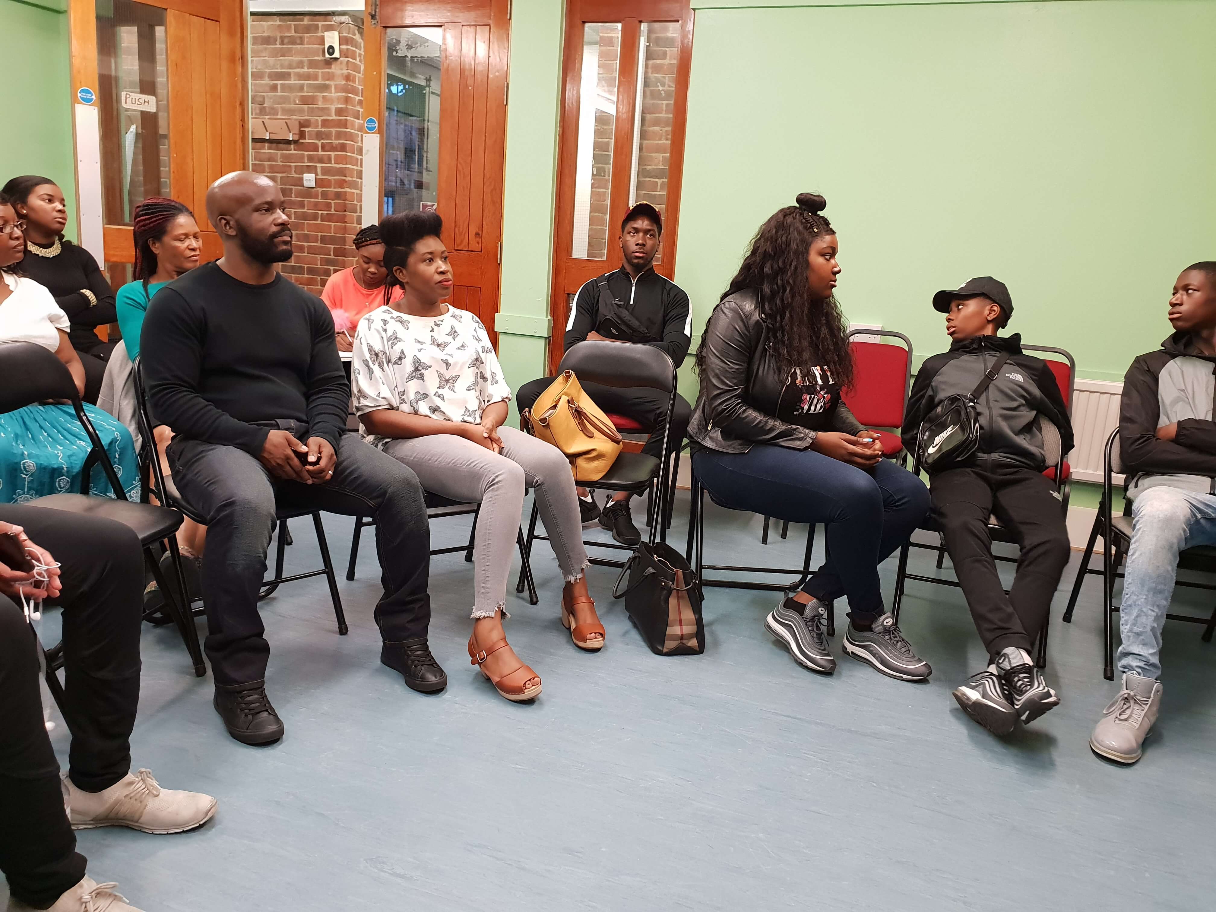 group of people engaged in a discussion about mentoring young people